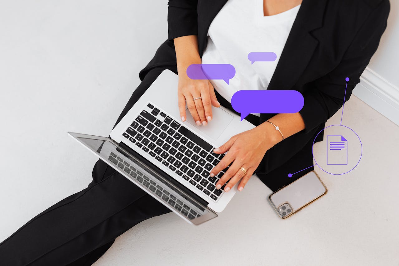 Services High-angle shot of a woman in black suit using a laptop, symbolizing digital communication.